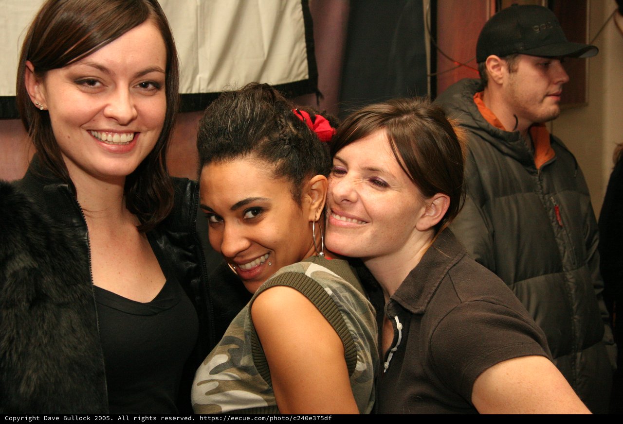 Three Friends Posing Together at a Party