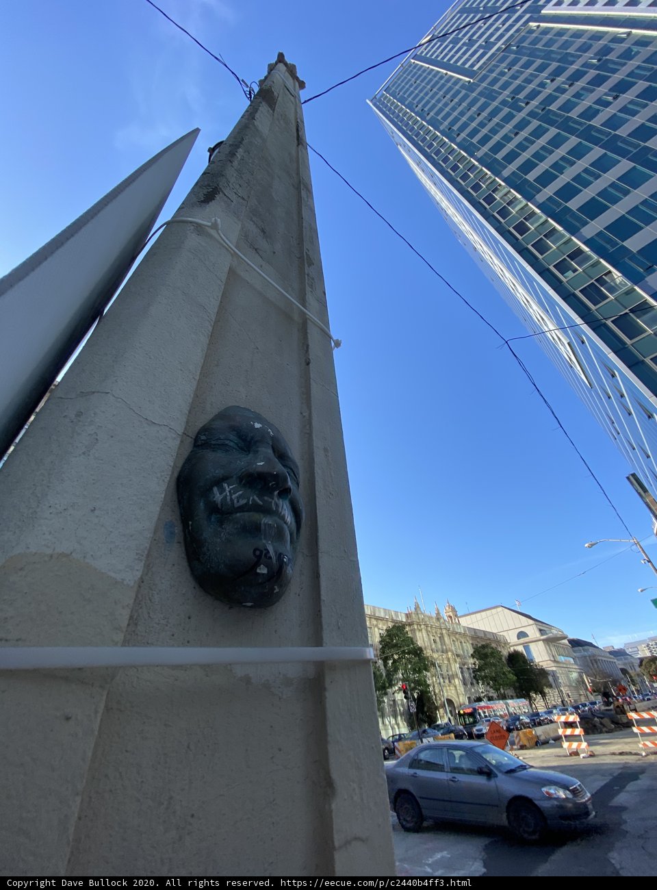 Man's Face Statue on Urban Building