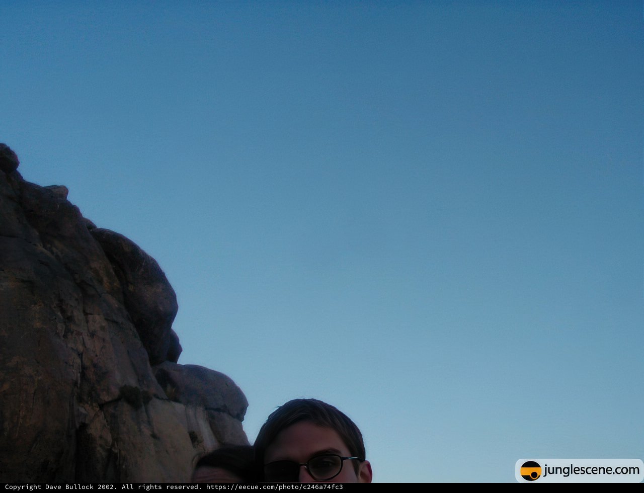 Standing Tall Against the Majestic Rock Formation