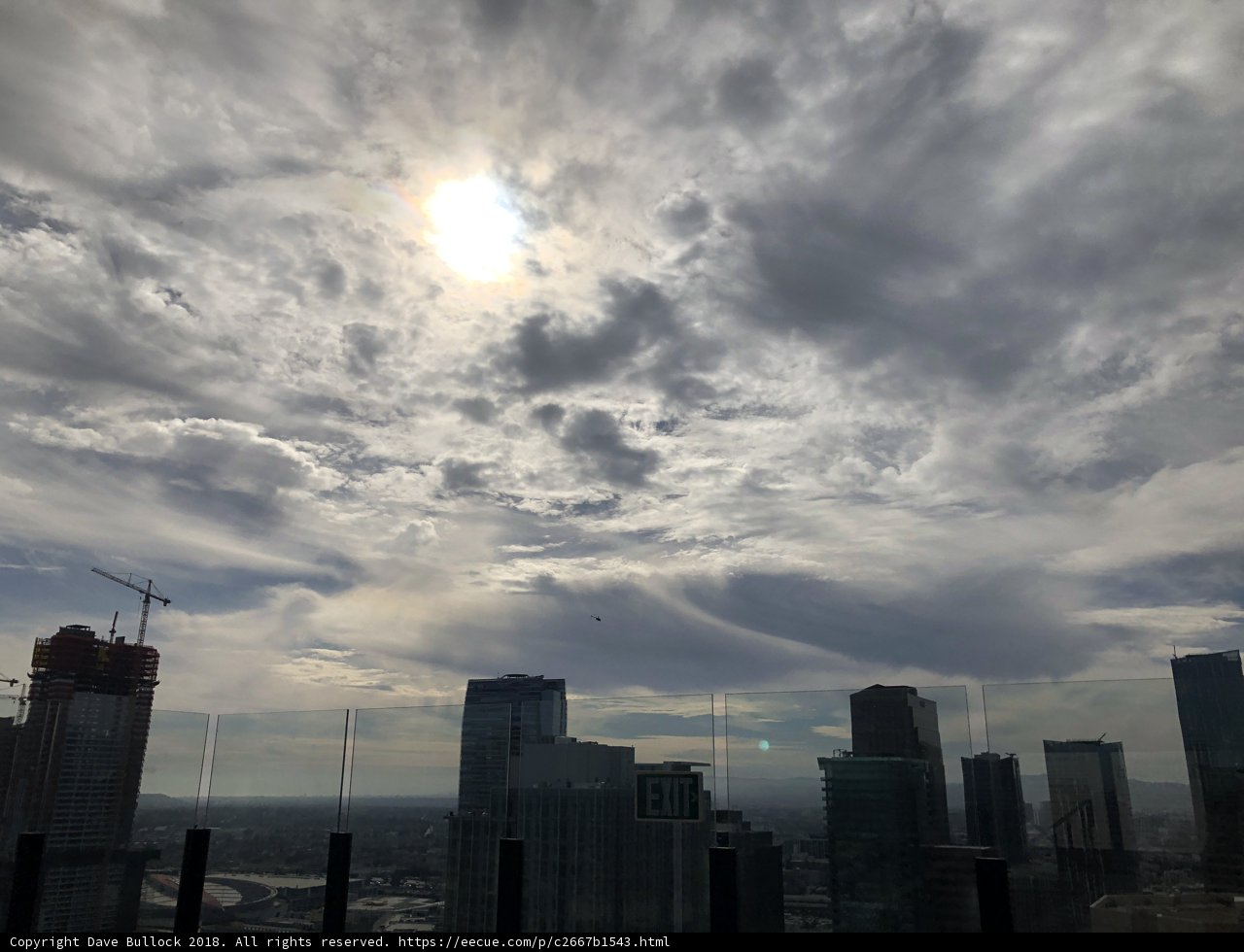 Sunlight breaks through cloudy cityscape