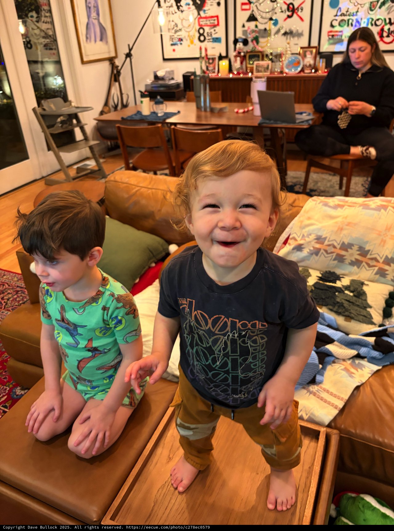 Joyful Toddler Standing on Coffee Table at Home
