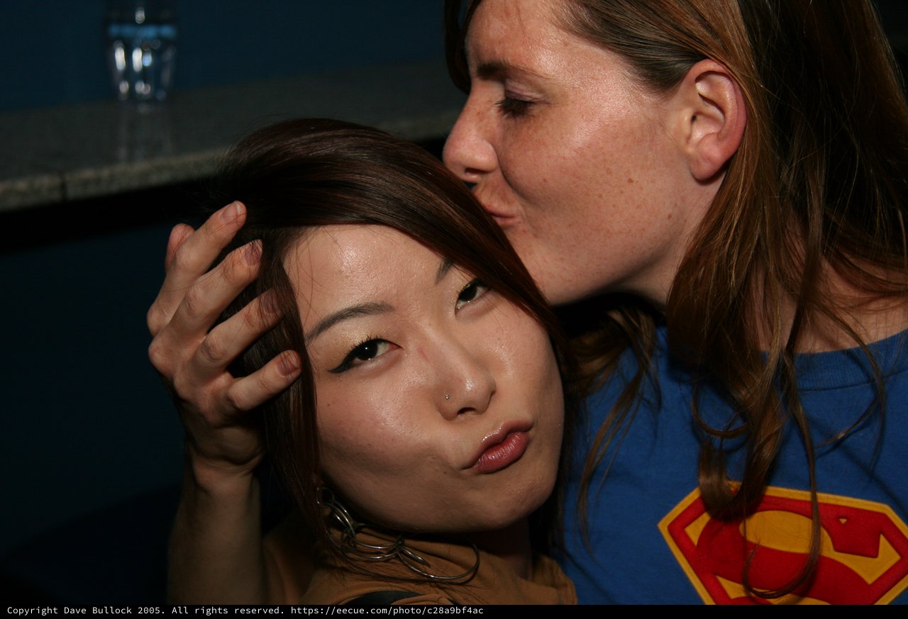 Two Friends Share a Playful Moment at a Bar