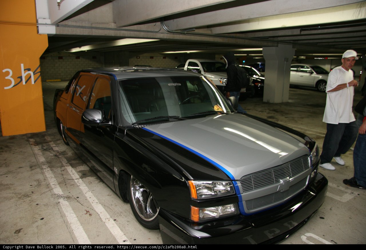 Black and Blue Chevy Truck in a Parking Garage