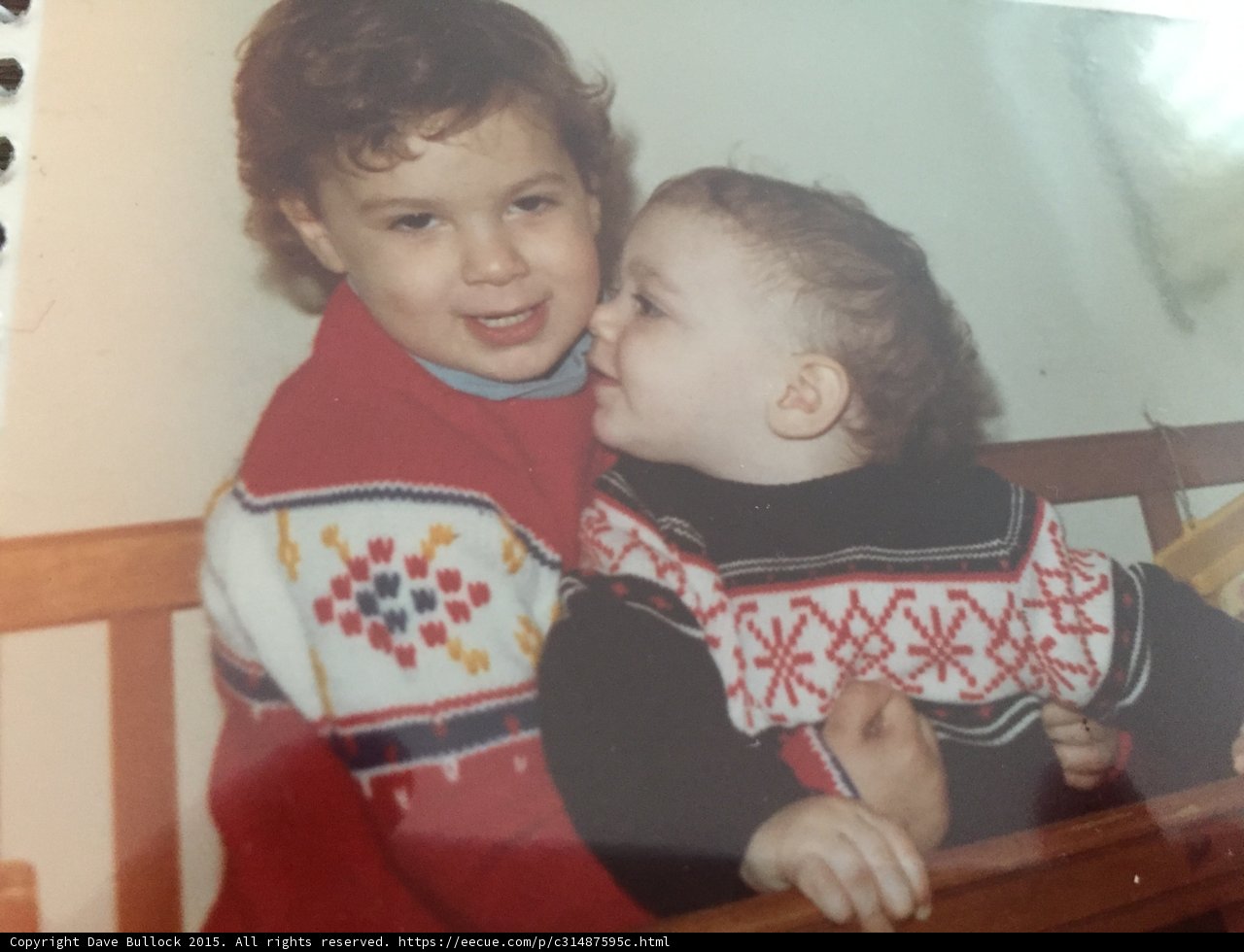 Sweater-clad brothers embrace