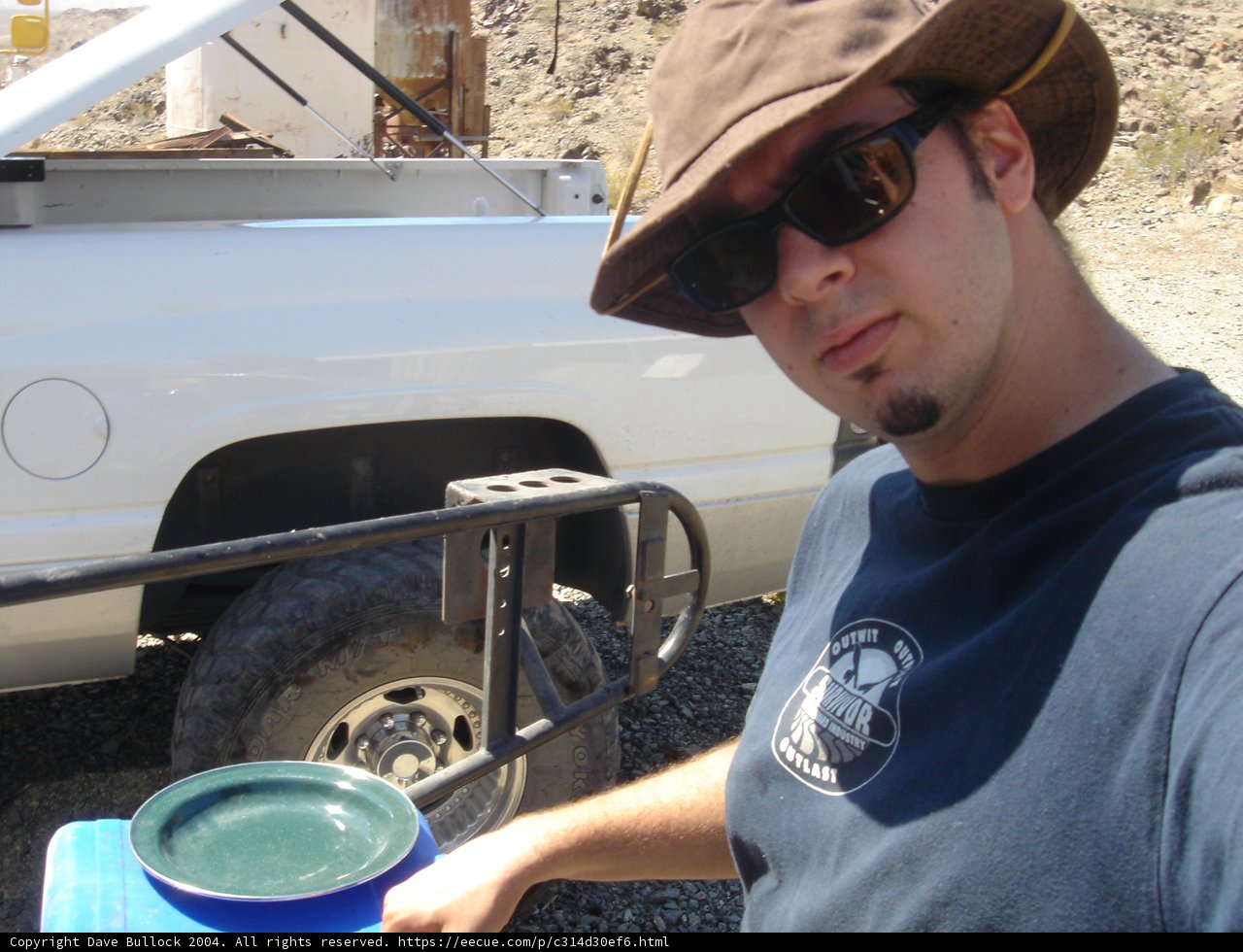 Man in Sunglasses and Hat with Pickup Truck