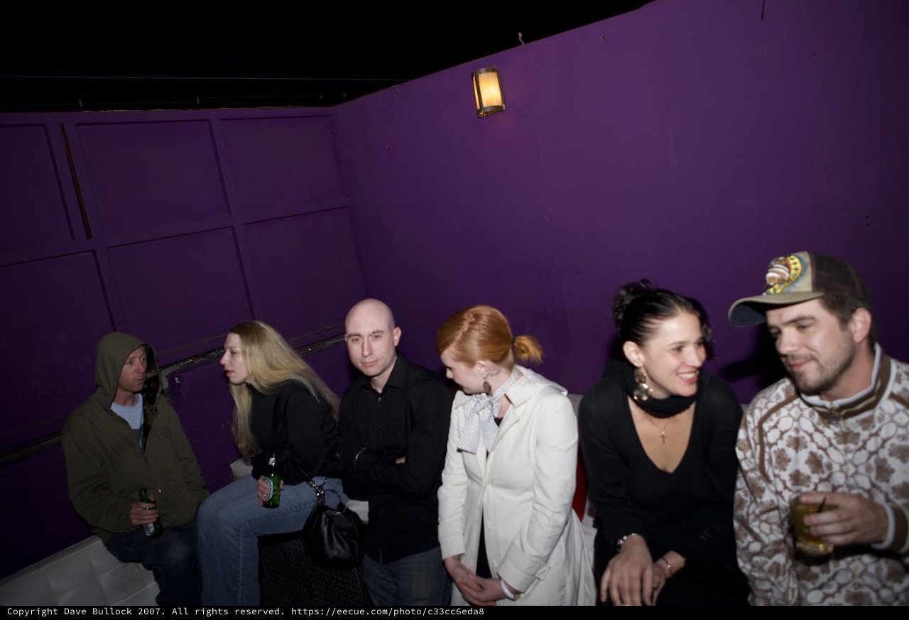 Friends Gathering at a Purple-Walled Nightclub Venue