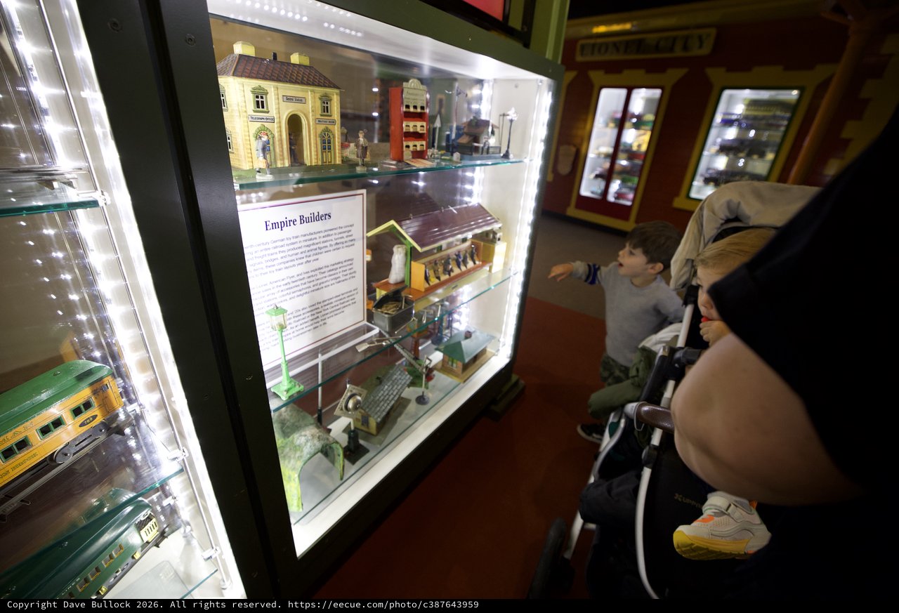 Family Exploring Model Train Display at Museum