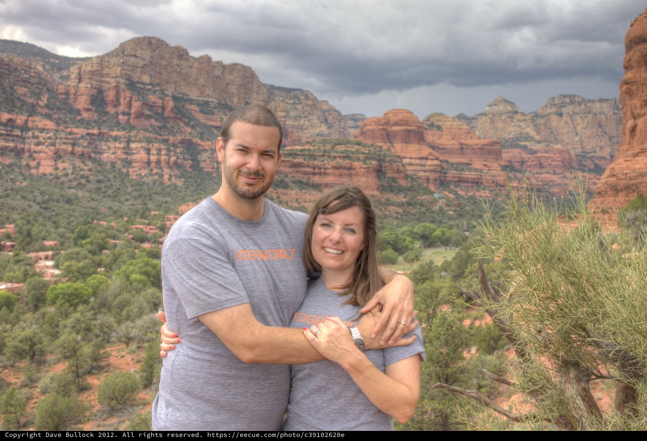 Couple Embracing Amid Sedona's Dramatic Red Rock Landscape
