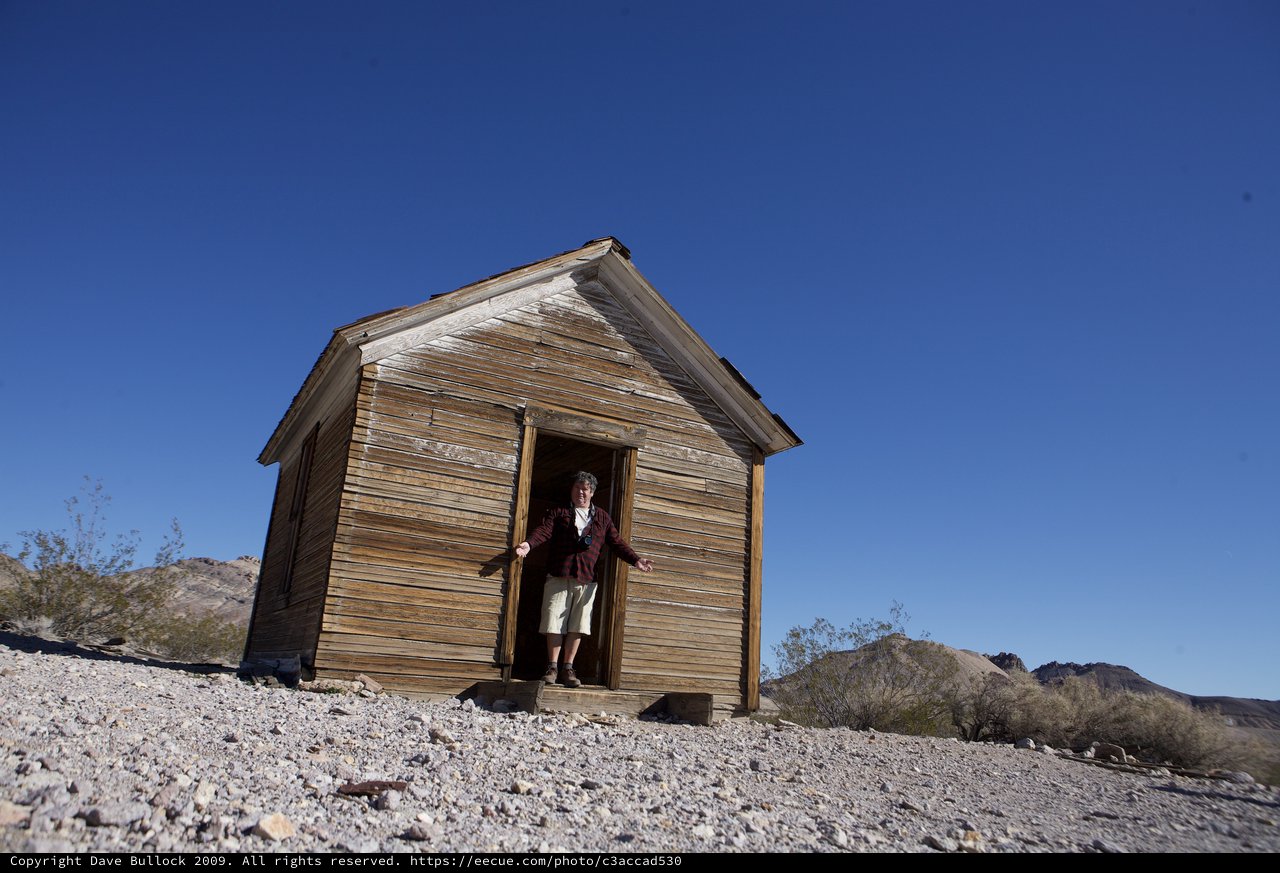 Explorer at Abandoned Desert Ghost Town Shack