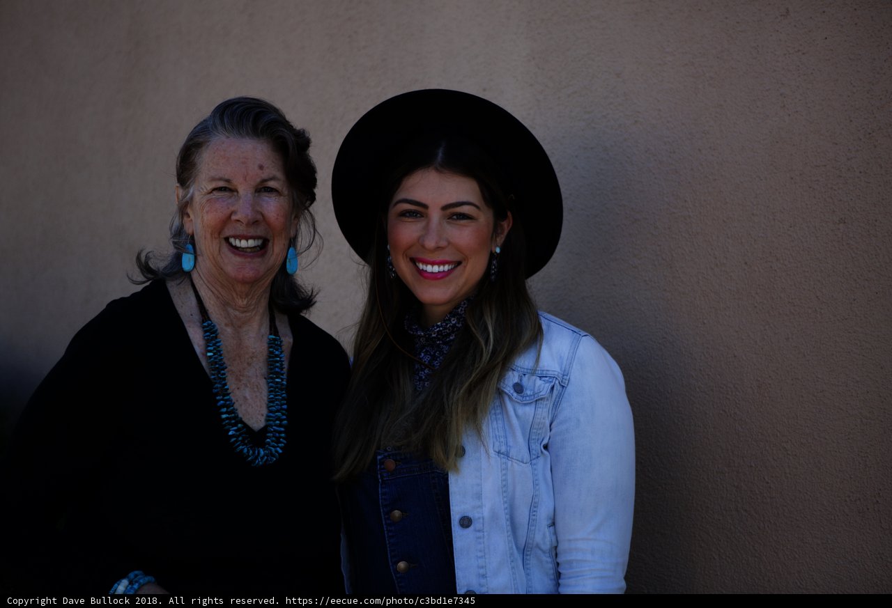 Two Happy Women in Hats and Black Shirts