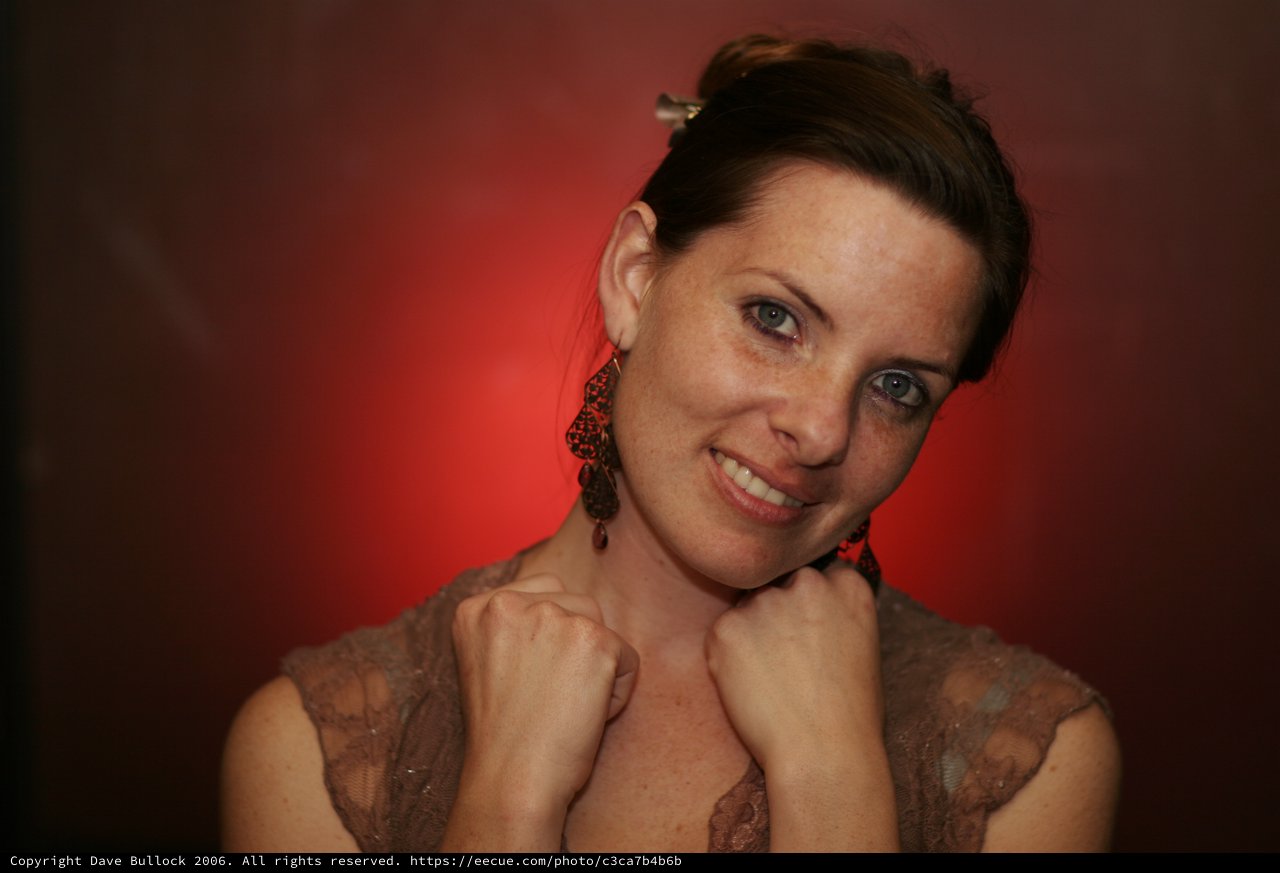 Penelope's Playful Portrait Against Crimson Backdrop