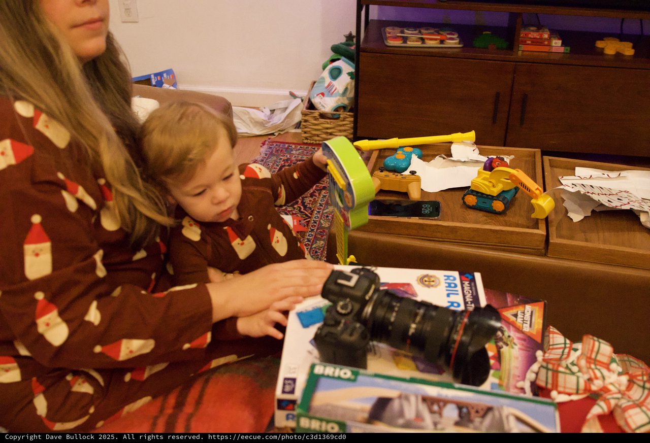 Child Opening Christmas Present with Camera