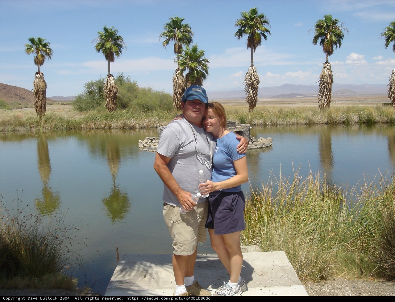 Couple Embracing at Desert Oasis Pond