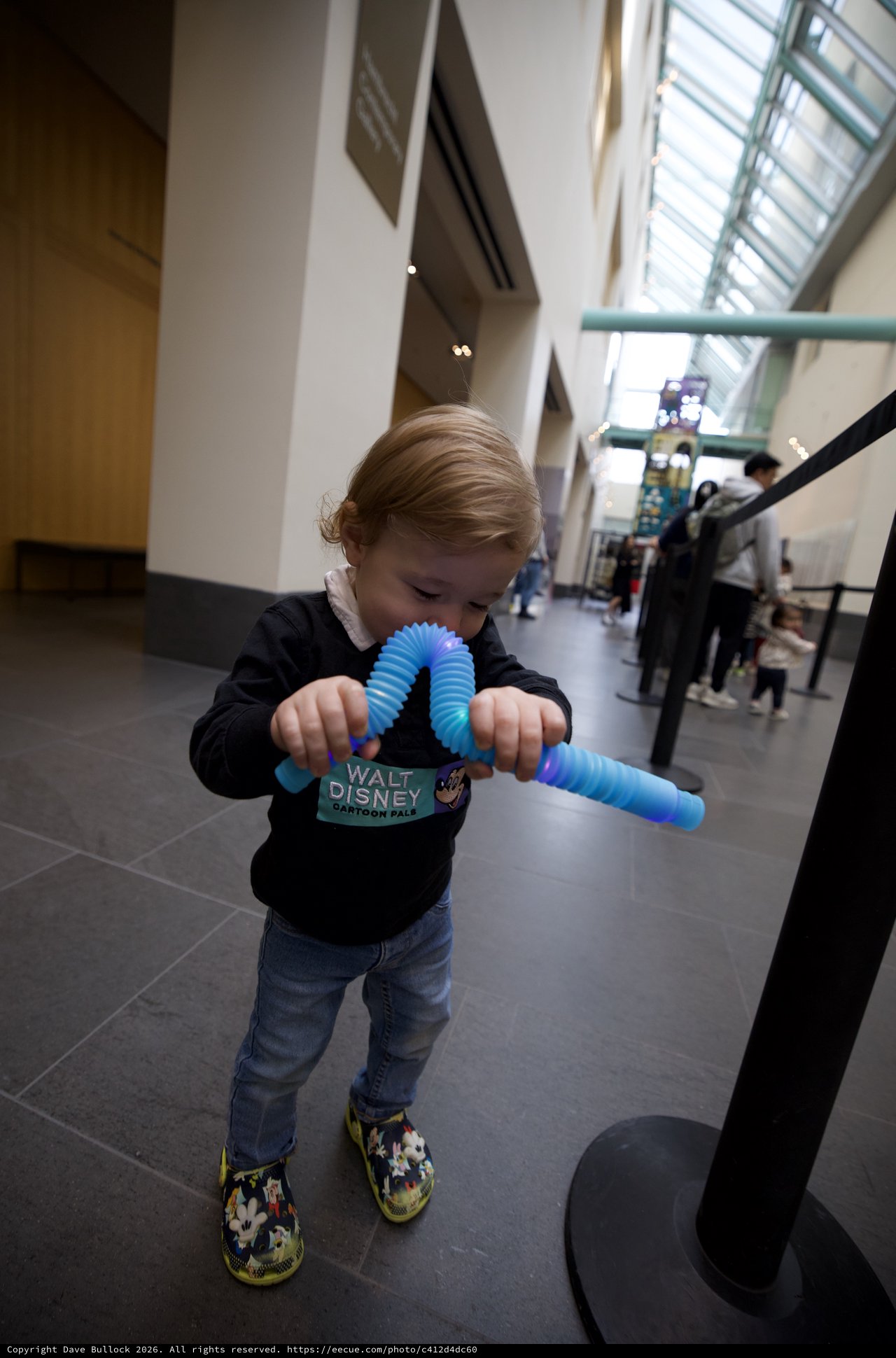 Toddler Playing with Blue Fidget Toy at Museum