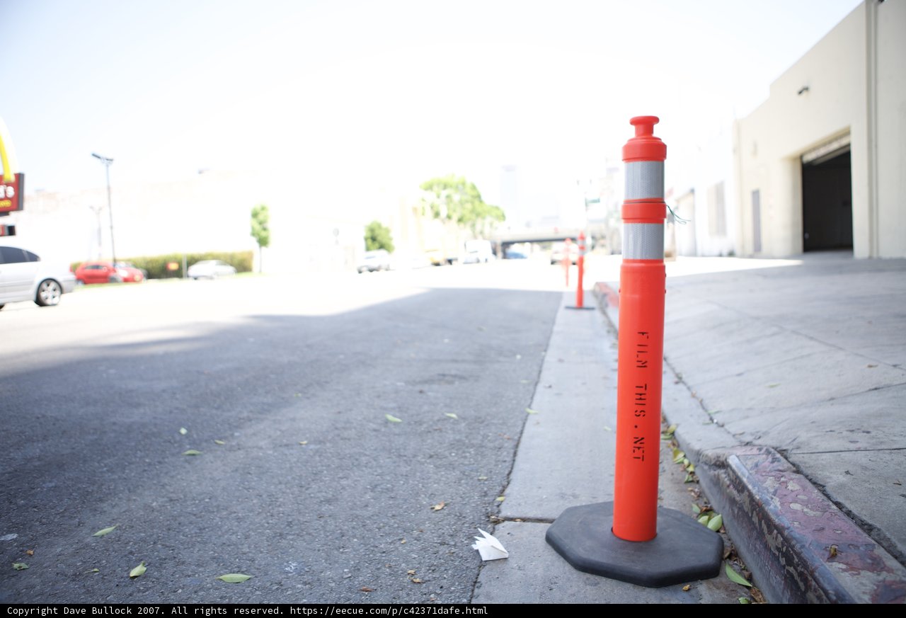 Red and White Traffic Cone on the City Street