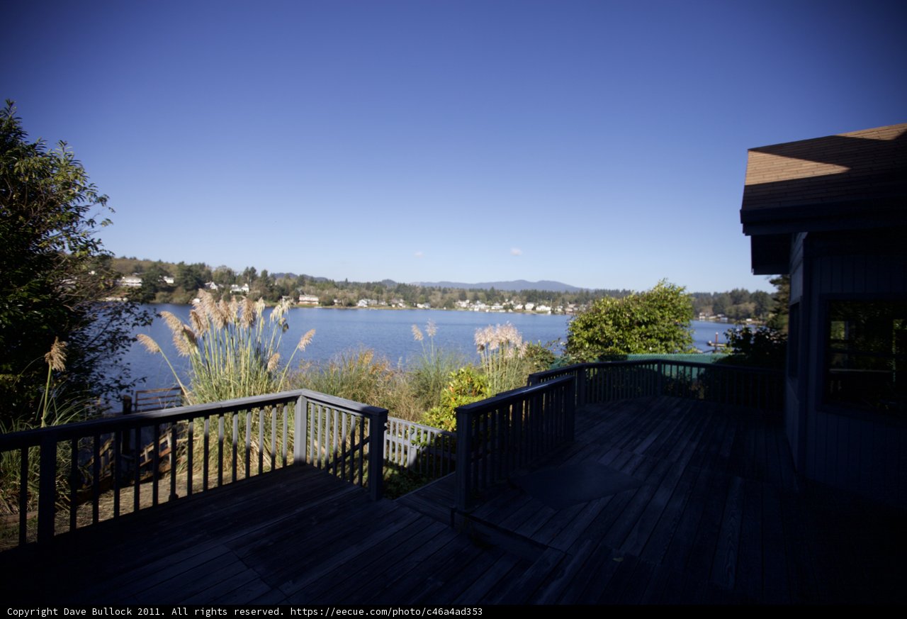 Serene view of lake from wooden deck