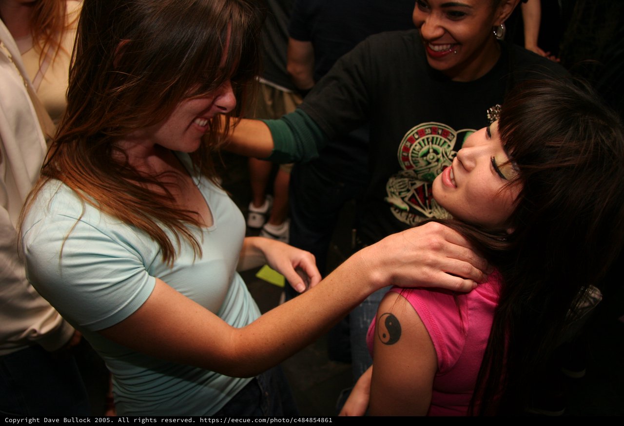 Friends Share a Playful Moment at Nightclub Event