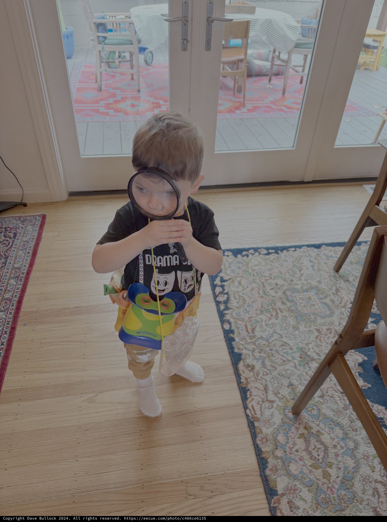 Child Playing Detective with Magnifying Glass