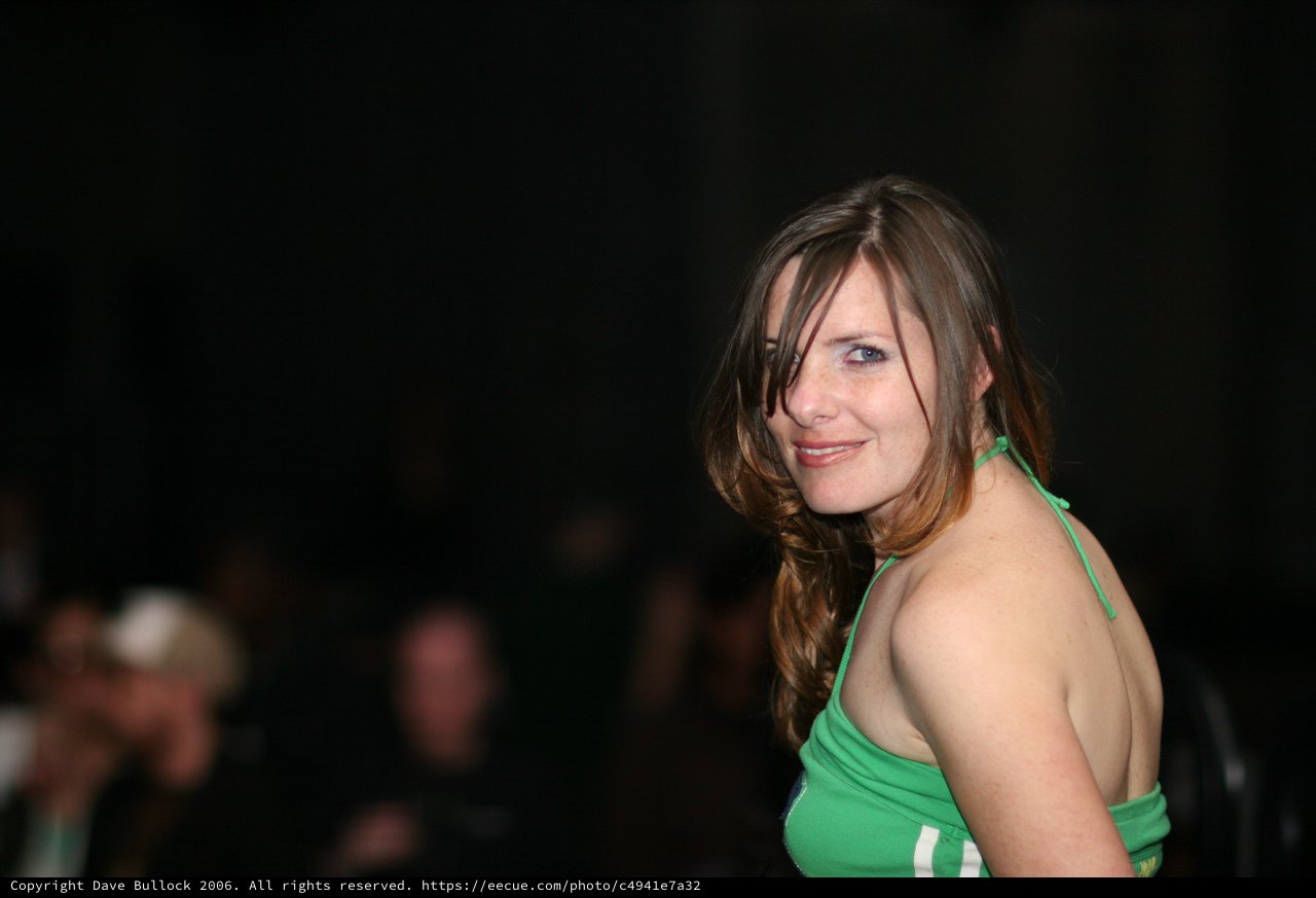 Woman in Green Halter Top Glances Over Shoulder