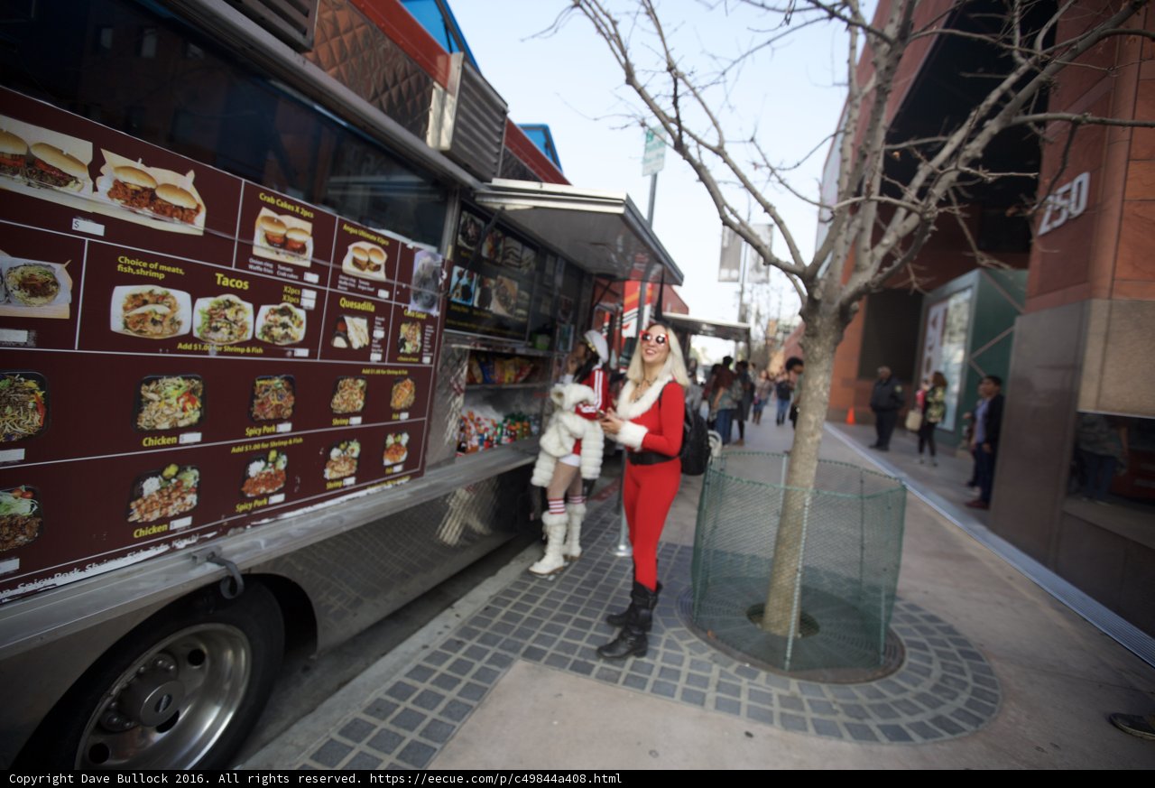 Santa Claus serves burgers from a food truck
