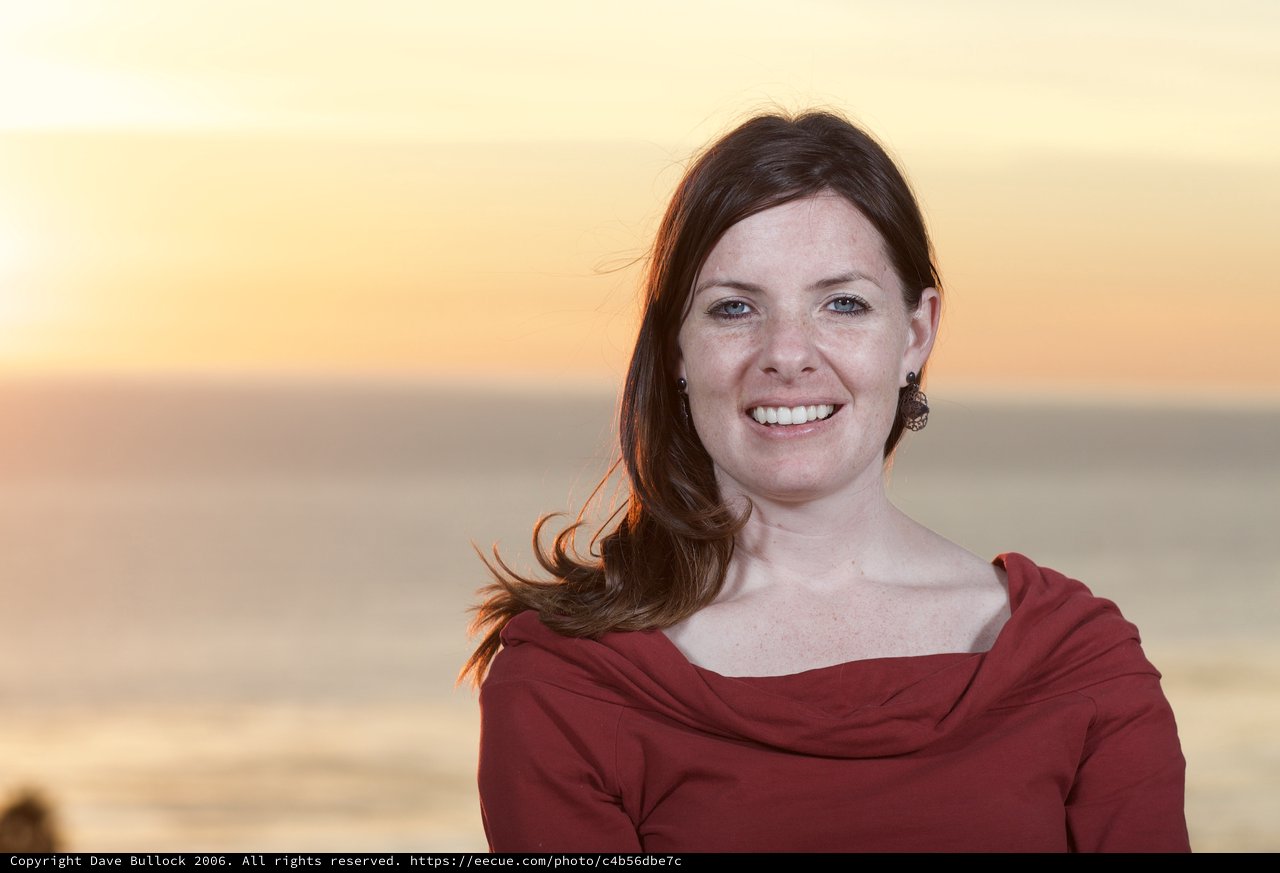 Radiant Woman Smiling at Golden Hour Beach