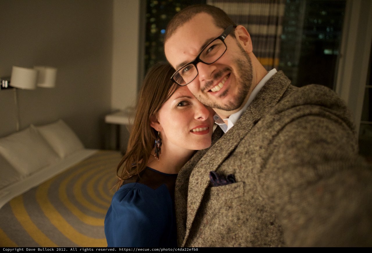 Romantic Couple Selfie in Warmly Lit Hotel Room