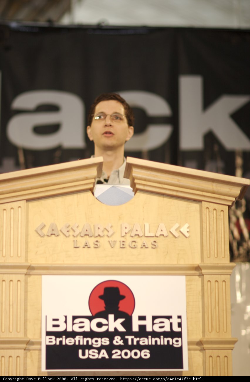 Jeff M delivering a speech in front of Black Hat sign