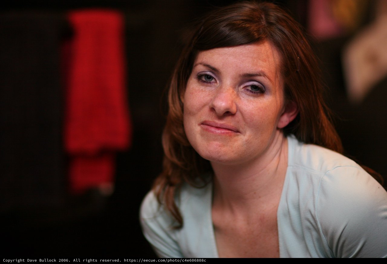 Thoughtful Woman in Soft Blue at Evening Event