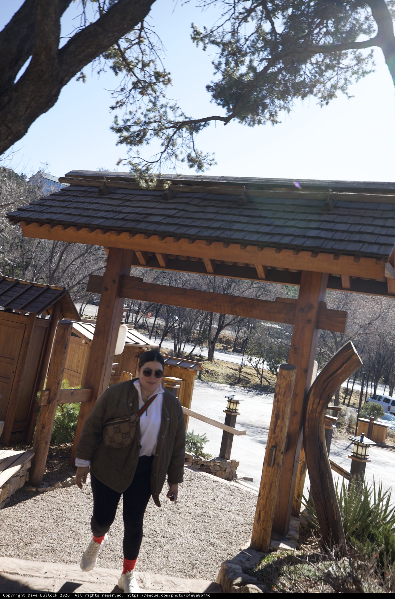 Visitor at Traditional Japanese-Style Garden Gate