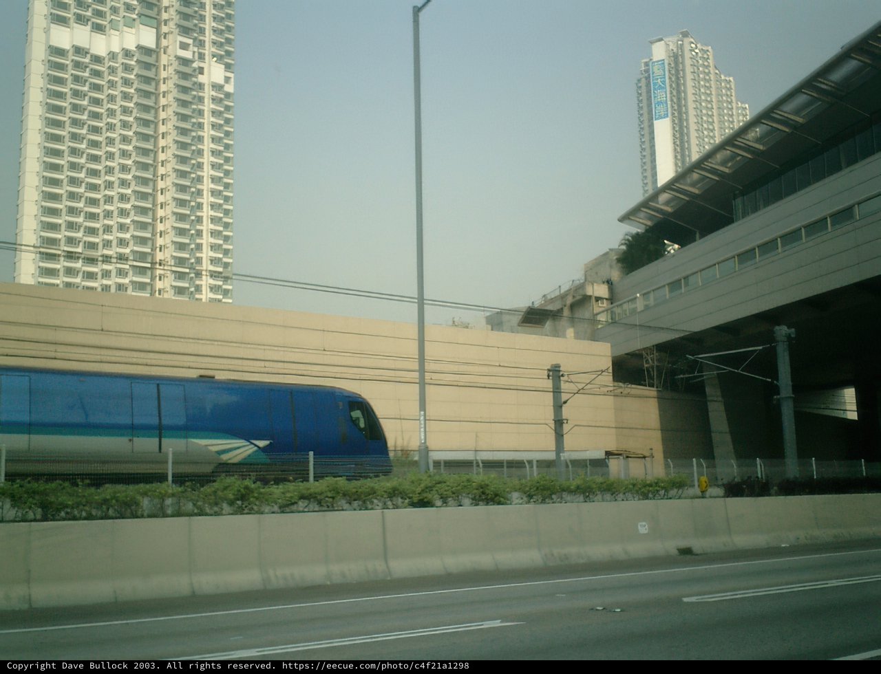 Train passing next to Urban Skyscraper