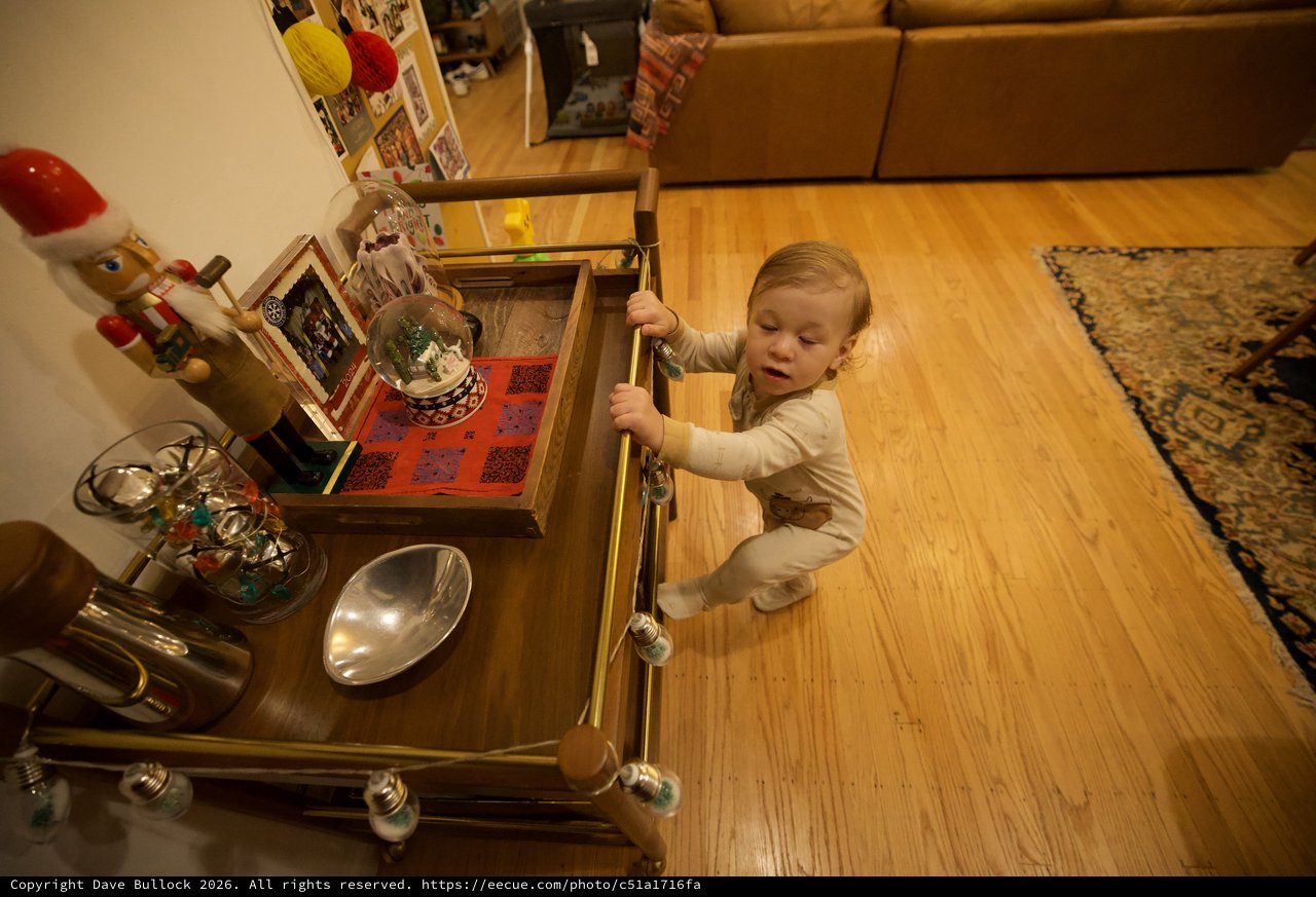 Toddler Exploring Holiday Decorations in Living Room Drawer