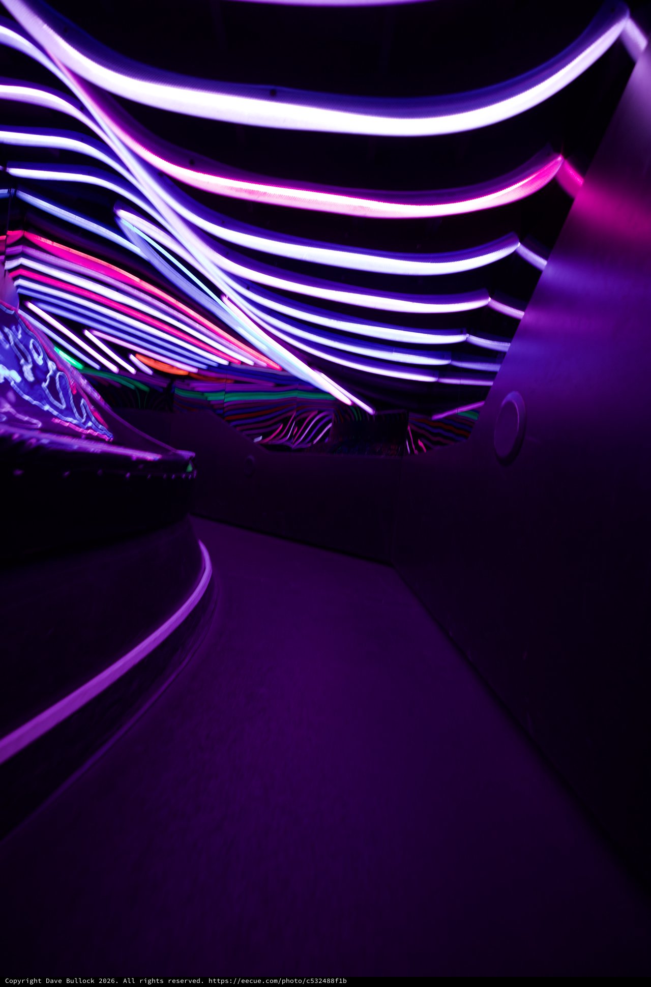 Neon Tunnel with Curved Light Strips and Purple Glow
