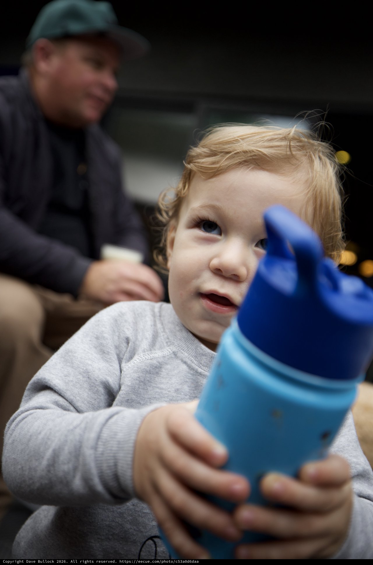 Young Child with Sippy Cup on Family Outing