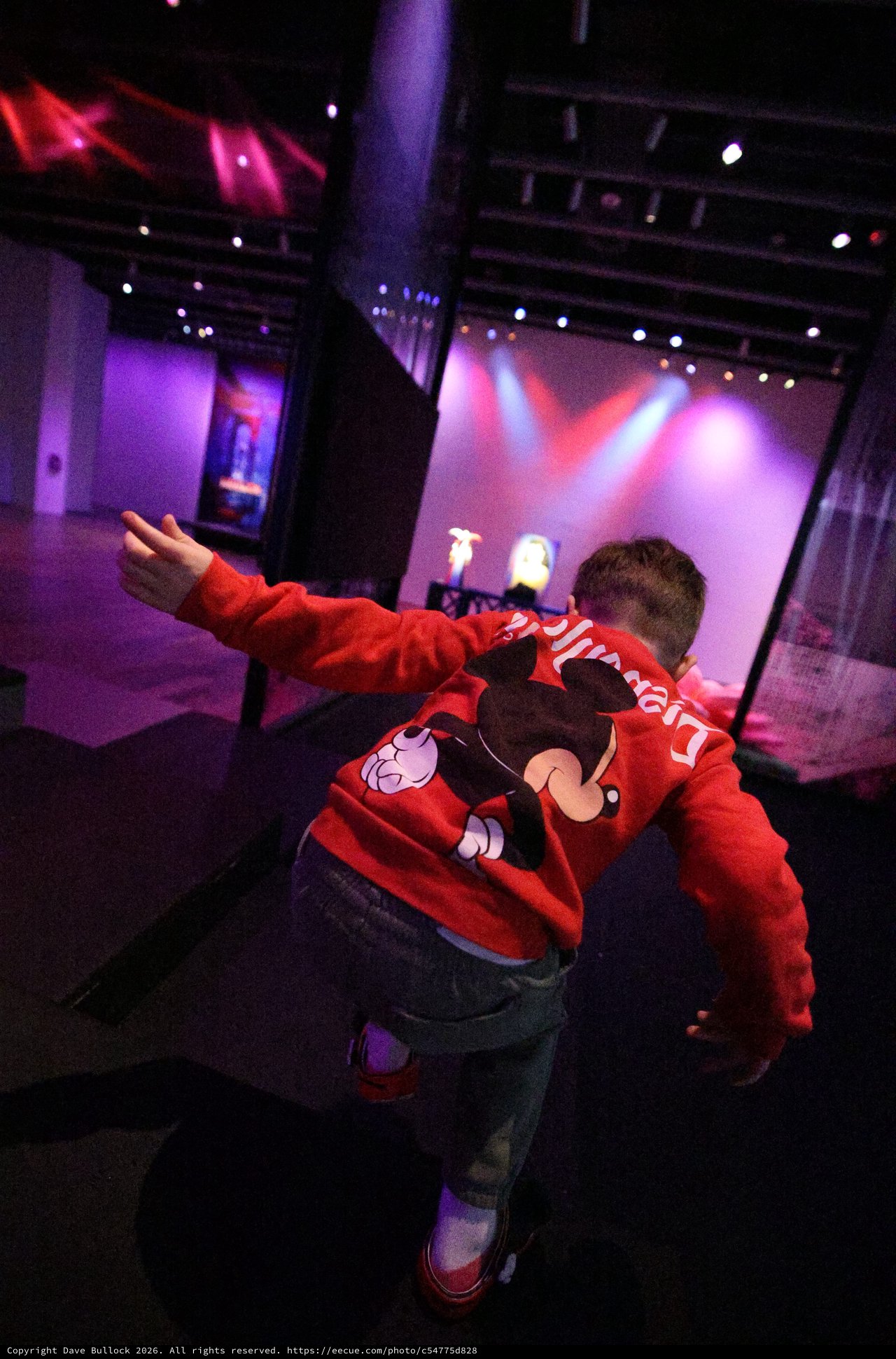 Child Pointing at Stage During Baby Rave Event