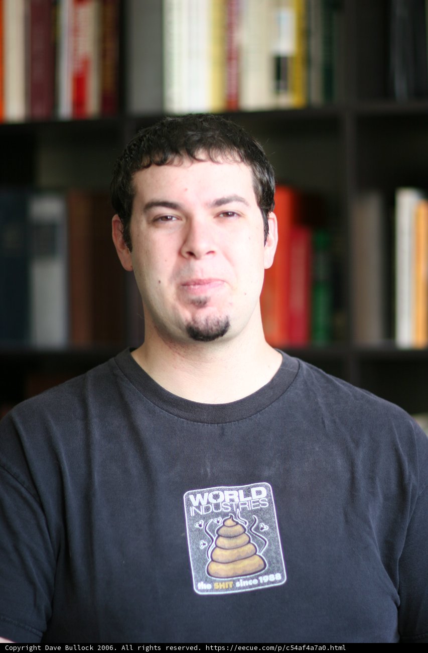 Dave B in front of his bookshelf
