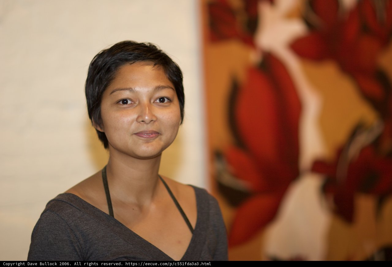 Woman Elegantly Poses in Front of Painting