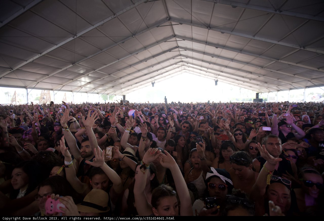 Concert-goers at Coachella raise their hands
