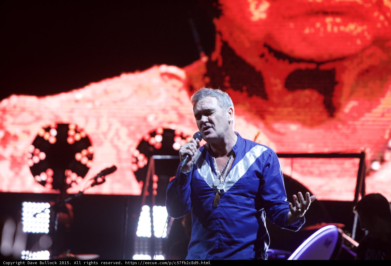 Morrissey Close Up Singing Hand Gesturing Blue Shirt Circular Lights Red Video Screen Face