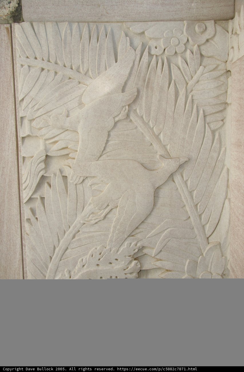 Intricate Carving of a Bird and Palm Leaves