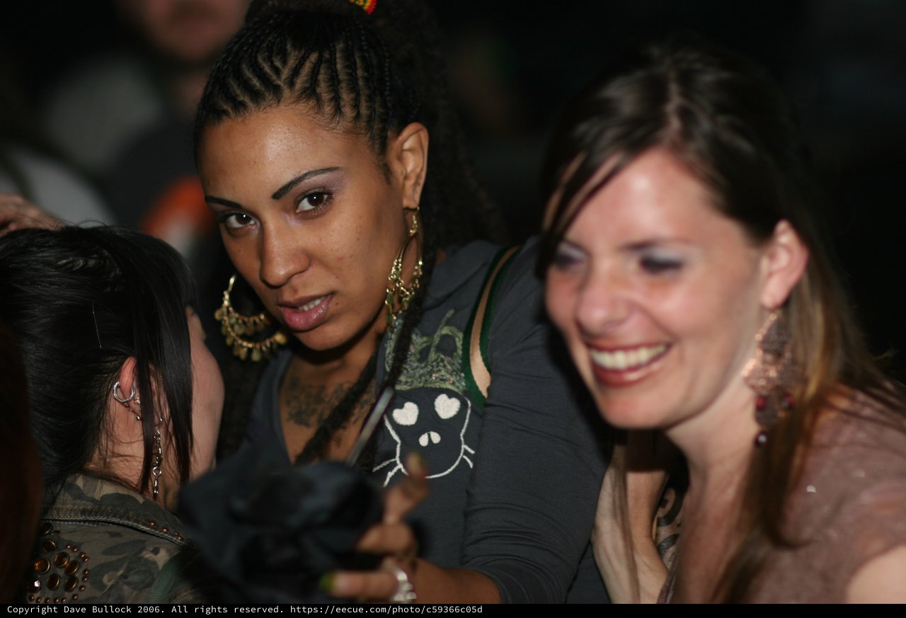 Three Women Socializing at a Nightclub Event