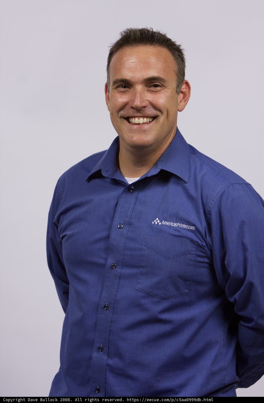 Blue-Shirted Man Grinning for the Camera