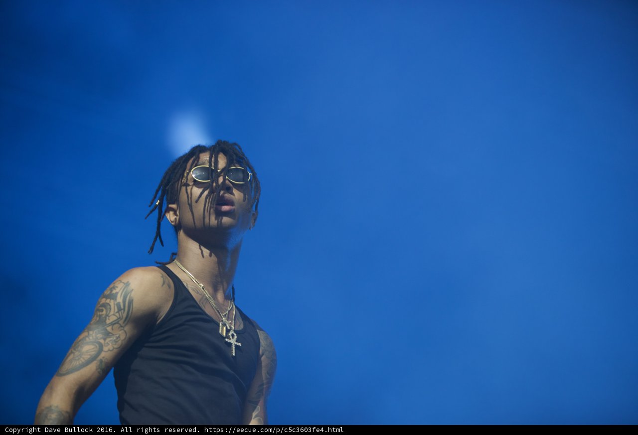 Man with tattoos performing on stage