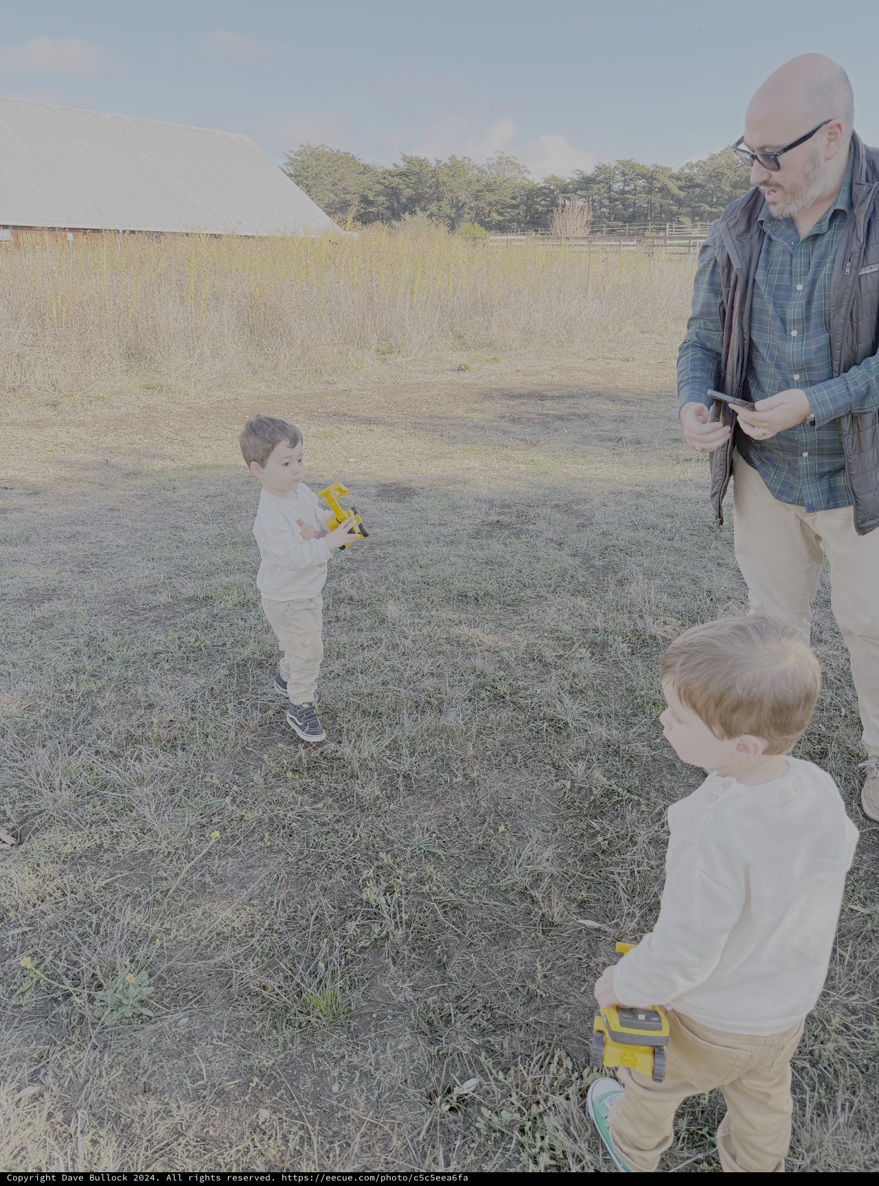 Grandfather Playing with Children in Rural Field
