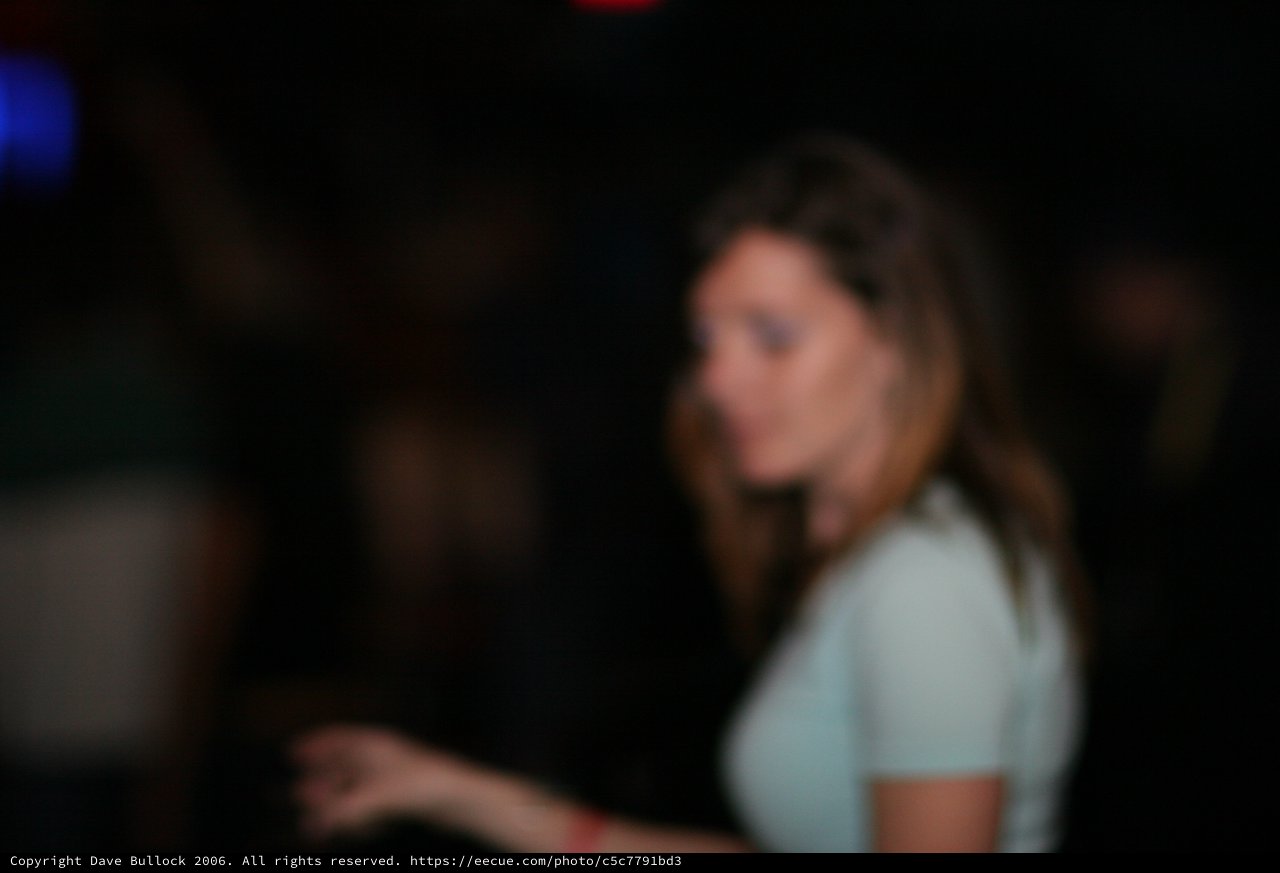 Woman Looking Back in Dark Nightclub Setting