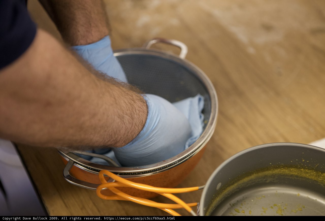 Cleaning a Pot with Blue Gloves
