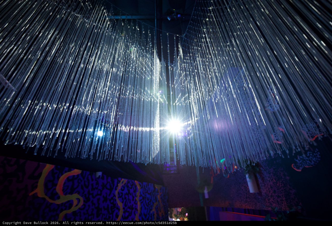Illuminated Crystal Chandelier Installation in Museum Space