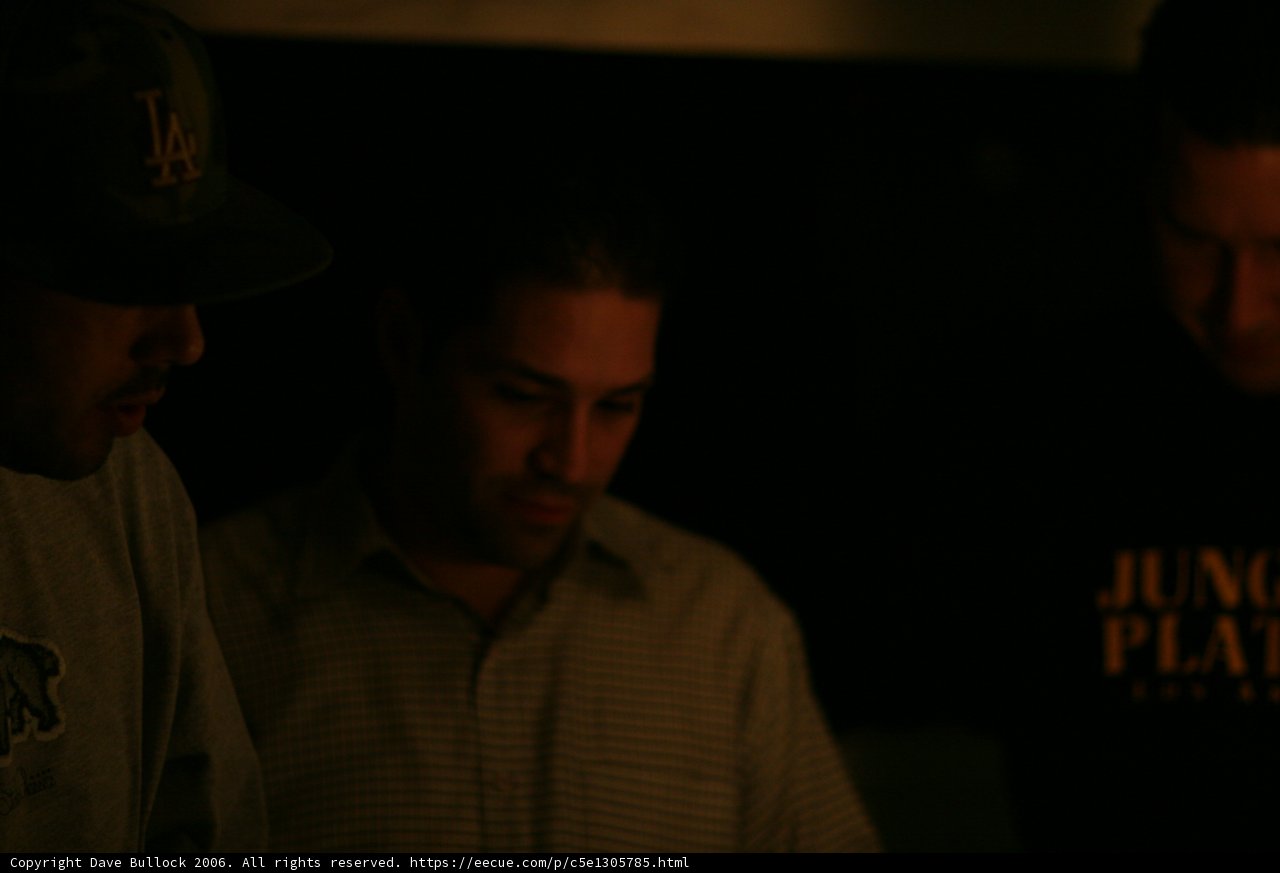 Grey Shirt, Baseball Cap, and Three Men