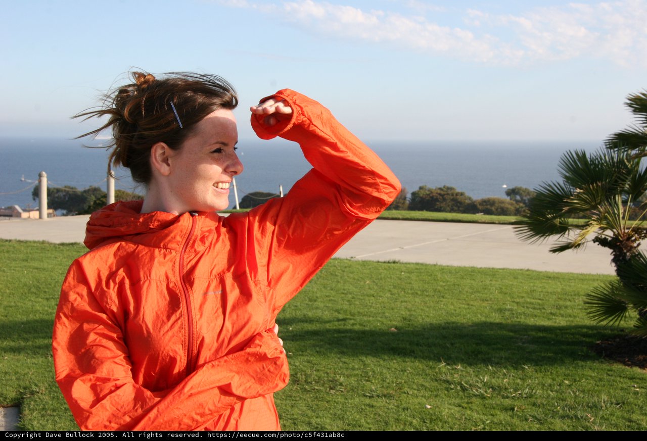 Windswept Woman Flexing by the Ocean Shore