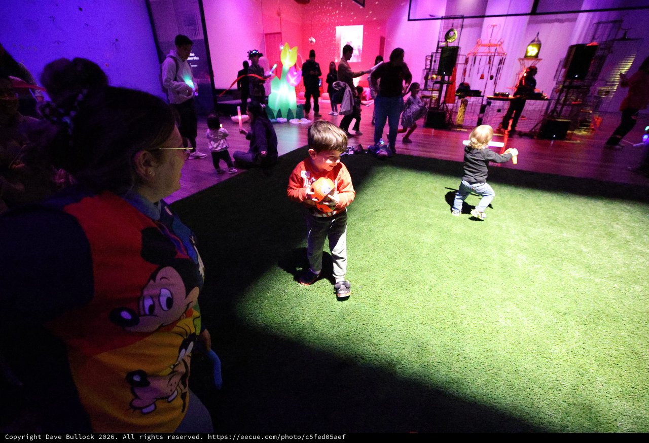Children Dancing Under Colorful Lights at Baby Rave Event