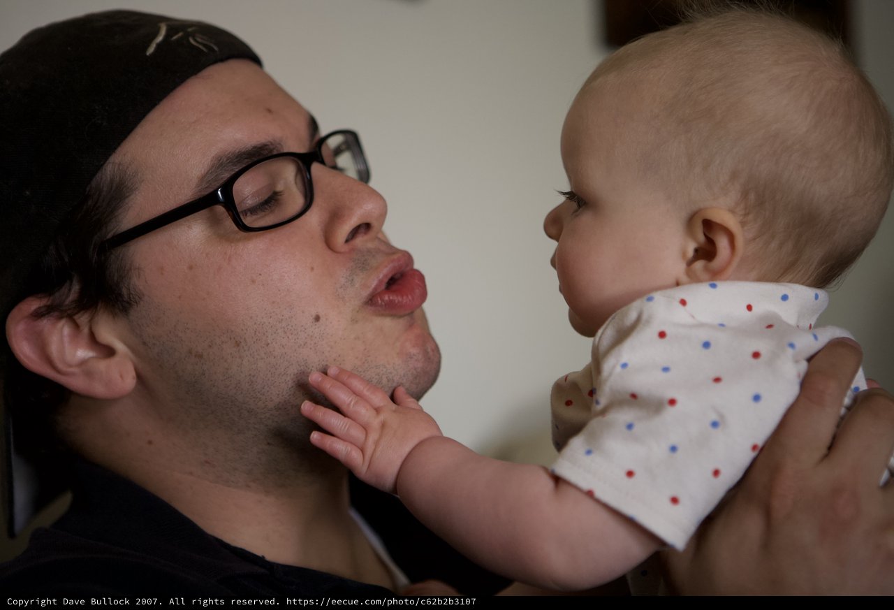 Father and Baby Share a Tender Playful Moment